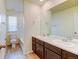 Bathroom featuring double sink vanity with elegant fixtures and ample counter space, plus a tub-shower combo at 5686 Eagle River Pl, Brighton, CO 80601