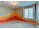 Stylish bedroom featuring unique painted mountain mural accent wall at 5686 Eagle River Pl, Brighton, CO 80601