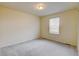 A neutral-toned bedroom with a window and soft carpet at 5686 Eagle River Pl, Brighton, CO 80601