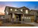 Charming two-story home featuring a two-car garage and a welcoming front porch, stone veneer, neutral color and meticulous landscaping at 5686 Eagle River Pl, Brighton, CO 80601