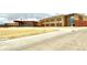 Exterior view of a modern school building with brick facade and well-maintained landscaping at 5686 Eagle River Pl, Brighton, CO 80601