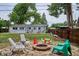Outdoor patio with a fire pit, lawn, and fenced yard providing space for leisure at 6055 E Minnesota Dr, Denver, CO 80224