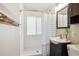 Bright bathroom featuring a shower with a curtain and a vanity with storage at 6055 E Minnesota Dr, Denver, CO 80224