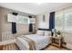 Comfortable bedroom with shuttered windows and a bed with patterned linens at 6055 E Minnesota Dr, Denver, CO 80224