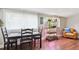Bright dining room with a classic table set, ample natural light, and hardwood floors at 6055 E Minnesota Dr, Denver, CO 80224