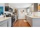 Modern kitchen with gray cabinets, stainless steel appliances, and hardwood floors at 6055 E Minnesota Dr, Denver, CO 80224