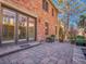 Brick home featuring an outdoor patio, stone pathway, mature trees and lush landscaping at 106 S University Blvd # 2, Denver, CO 80209