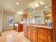 Dual sink bathroom featuring wood cabinetry, granite countertop, and a large mirror that reflects the entire room at 106 S University Blvd # 2, Denver, CO 80209