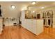 Spacious walk-in closet with custom shelving, center island with drawers and hanging racks on a wood floor at 106 S University Blvd # 2, Denver, CO 80209