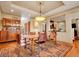Formal dining room featuring hardwood floors, a rustic table with seating, and an elegant chandelier at 106 S University Blvd # 2, Denver, CO 80209