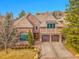 Elegant brick home with a two-car garage, arched window, and manicured landscaping at 106 S University Blvd # 2, Denver, CO 80209