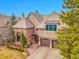 Charming brick home featuring a manicured lawn, mature trees, and a three-car garage at 106 S University Blvd # 2, Denver, CO 80209