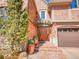 Inviting front entrance with a beautiful wooden door, brick steps, and decorative planters at 106 S University Blvd # 2, Denver, CO 80209