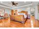 Spacious main bedroom featuring hardwood floors, tray ceiling, and an attached closet at 106 S University Blvd # 2, Denver, CO 80209