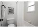 Well-lit bathroom including a shower and tub combination, featuring framed wall art and clean, white tiling at 6755 S Field St # 625, Littleton, CO 80128
