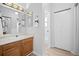 A clean bathroom featuring neutral-toned cabinets and hardware with bright, white walls at 6755 S Field St # 625, Littleton, CO 80128