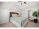 A serene bedroom features a comfortable bed, houseplant, and closet with a large window at 6755 S Field St # 625, Littleton, CO 80128