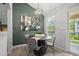 Dining area highlighted by a modern light fixture, colorful wall art, and a balcony view at 6755 S Field St # 625, Littleton, CO 80128