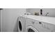 A well-lit laundry room featuring a modern, front-load washer and dryer set, perfect for efficient laundry care at 6755 S Field St # 625, Littleton, CO 80128