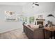 Open-concept living room with a fireplace, sliding glass door access to a balcony, and views to the kitchen at 6755 S Field St # 625, Littleton, CO 80128