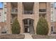 Condo building entrance with stone accents and stairs at 7292 S Blackhawk St # 2-103, Englewood, CO 80112