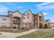 Attractive 2-story condo building with landscaping and walkway at 7292 S Blackhawk St # 2-103, Englewood, CO 80112