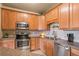 Open concept kitchen with island and stainless steel appliances at 7292 S Blackhawk St # 2-103, Englewood, CO 80112