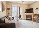 Living room with fireplace, TV, and patio access at 7292 S Blackhawk St # 2-103, Englewood, CO 80112
