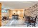 Finished basement with stone and wood accents, a small bar, and a barrel table at 5567 Irish Pat Murphy Dr, Parker, CO 80134