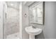 Bathroom features white marble tiling in shower and vanity with vessel sink and gray wall at 10555 Montview Blvd, Aurora, CO 80010