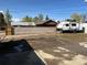 The front yard features an ample space for parking, accented by a charming Coleman trailer at 10555 Montview Blvd, Aurora, CO 80010