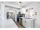 Modern kitchen features white cabinets, stainless steel appliances, tile backsplash, and quartz countertops at 10555 Montview Blvd, Aurora, CO 80010