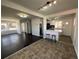 Open-concept living space boasts hardwood floors and a kitchen island with stool seating at 10555 Montview Blvd, Aurora, CO 80010