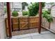 Outdoor area featuring a wood fence and manicured hedges at 1128 S Ventura Cir # K, Aurora, CO 80017