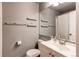 Clean, gray bathroom with a single sink vanity, toilet, and shower/tub combination at 1128 S Ventura Cir # K, Aurora, CO 80017