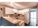 Well-lit kitchen featuring white cabinetry, modern appliances, and bar seating at 1128 S Ventura Cir # K, Aurora, CO 80017