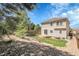 The backyard features a patio, retaining wall, lawn, and rock beds at 2354 Cactus Bloom Ct, Castle Rock, CO 80109