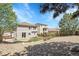 Backyard featuring a rock garden, lawn, trees, and wood fence at 2354 Cactus Bloom Ct, Castle Rock, CO 80109