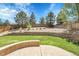 Manicured backyard featuring a retaining wall, lawn, and wood fence at 2354 Cactus Bloom Ct, Castle Rock, CO 80109
