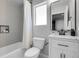Modern bathroom with a shower-tub combo, white vanity, and stylish fixtures, creating a clean and functional space at 2354 Cactus Bloom Ct, Castle Rock, CO 80109