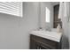 Bathroom features an undermount sink with wood vanity, tiled accent wall, and modern mirror at 2354 Cactus Bloom Ct, Castle Rock, CO 80109