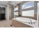 Luxurious bathroom featuring a soaking tub, separate shower, and ample natural light from the window at 2354 Cactus Bloom Ct, Castle Rock, CO 80109