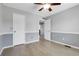 Bedroom featuring hardwood floors, neutral paint, and a white door at 2354 Cactus Bloom Ct, Castle Rock, CO 80109