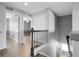 Upstairs hallway with wood floors and black wrought iron banister at 2354 Cactus Bloom Ct, Castle Rock, CO 80109