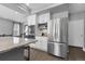 Kitchen with stainless steel refrigerator and appliances, granite counters, and hardwood flooring at 2354 Cactus Bloom Ct, Castle Rock, CO 80109