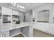 Bright kitchen features an island, white cabinets, tile backsplash, and stainless appliances at 2354 Cactus Bloom Ct, Castle Rock, CO 80109