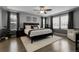Bright main bedroom featuring a ceiling fan, stylish decor, and plenty of natural light from the large windows at 2354 Cactus Bloom Ct, Castle Rock, CO 80109