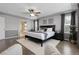 Spacious main bedroom with elegant decor, large windows, and a view into the adjoining bathroom at 2354 Cactus Bloom Ct, Castle Rock, CO 80109