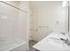 Well-lit bathroom featuring a double vanity, tub/shower combo with white tiling, and a linen closet at 1884 Sawtooth Mountain Dr, Berthoud, CO 80513