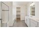 Bright bathroom features a double vanity, separate toilet room, and glass-enclosed shower/tub combo at 1884 Sawtooth Mountain Dr, Berthoud, CO 80513